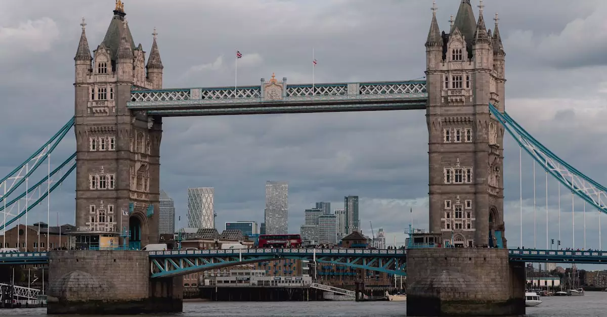 Iconic Tower Bridge view with Thames River in London, capturing classic architecture against a moody skyline.