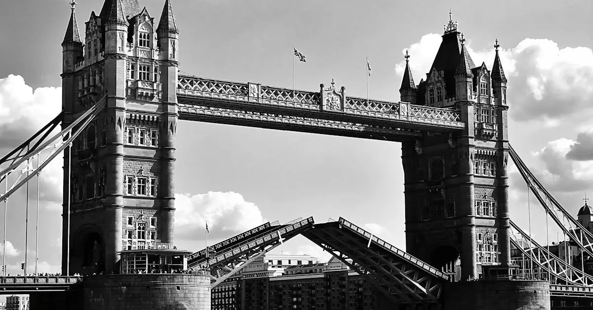 Stunning black and white capture of London's Tower Bridge with raised bascules against a cloudy sky.