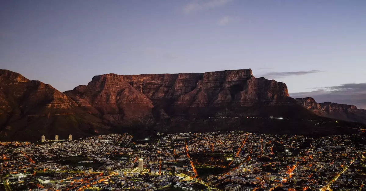A breathtaking aerial view of Cape Town at dusk with the iconic Table Mountain backdrop.