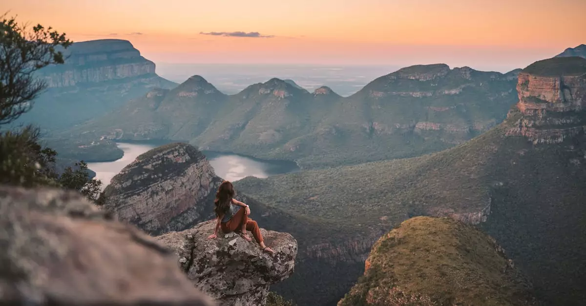 A serene view of a woman enjoying the sunset over a stunning canyon landscape, perfect for adventure inspiration.