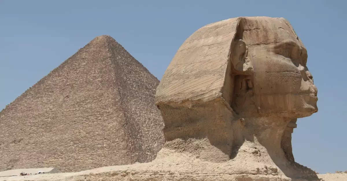 The Great Sphinx and Pyramid of Giza under a clear blue sky, capturing ancient Egypt's historical essence.