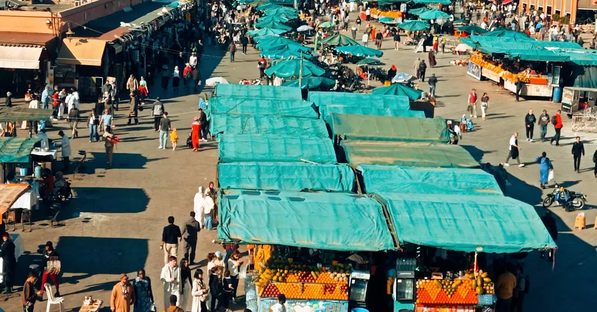 A bustling outdoor market in Marrakesh with colorful stalls and shoppers.