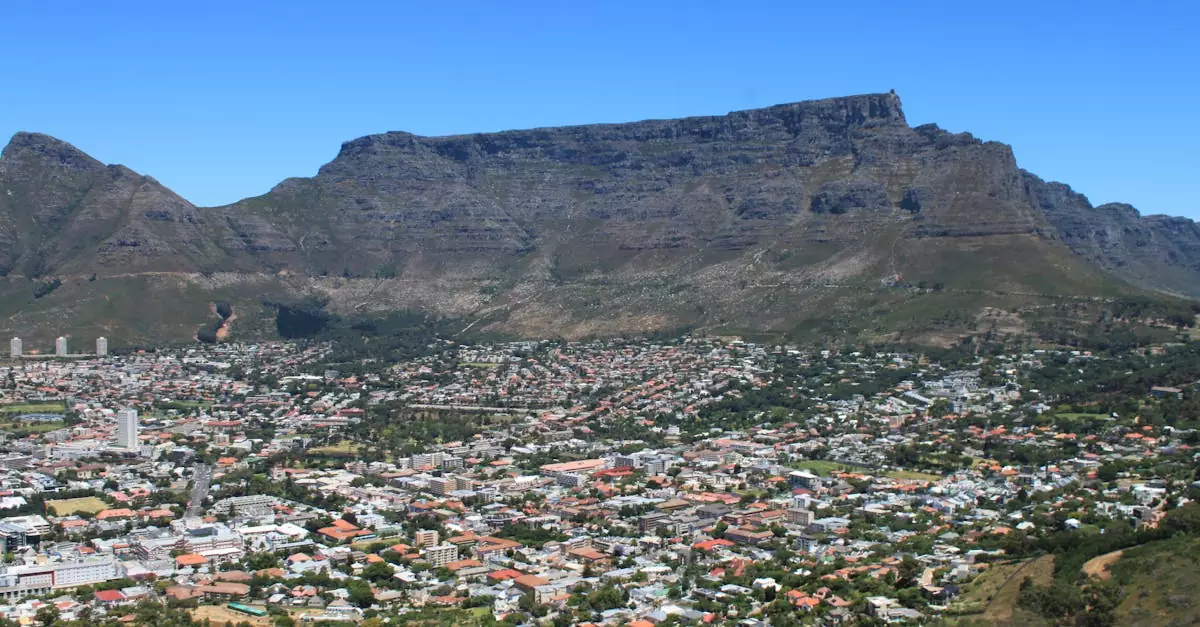 Scenic aerial view of Cape Town cityscape with iconic Table Mountain in the backdrop.