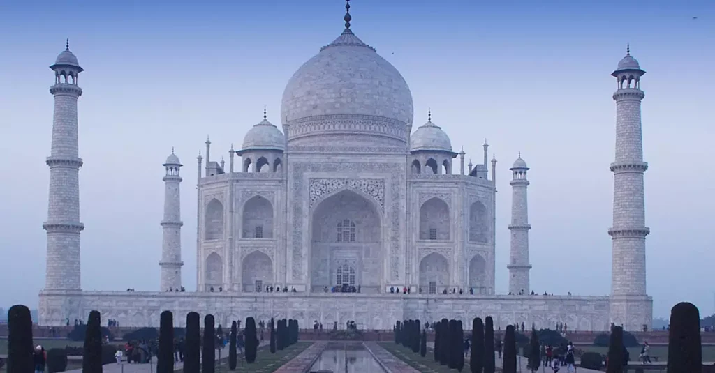 Asia's Best Ancient Landmarks: A Journey Through Time 7 Stunning photo of the iconic Taj Mahal with its reflection at twilight, showcasing Mughal architecture.