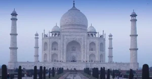 Stunning photo of the iconic Taj Mahal with its reflection at twilight, showcasing Mughal architecture.