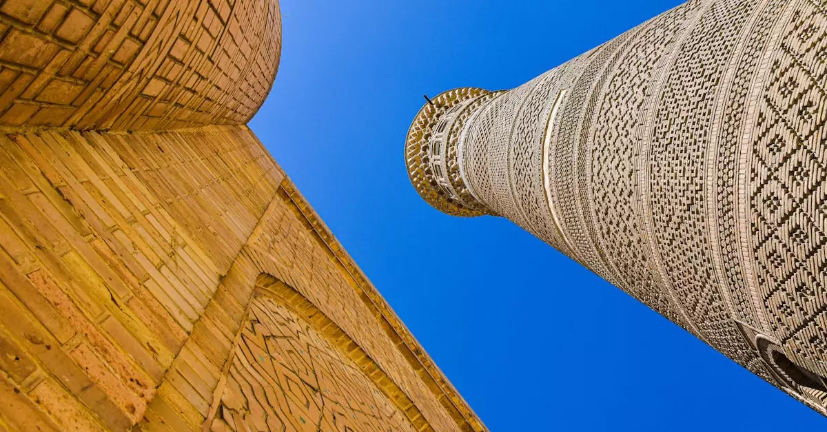 Imposing minaret of Po-i-Kalyan against clear blue sky, showcasing exquisite Islamic architecture.