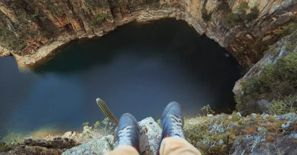 A breathtaking view from above a canyon with a deep lake, capturing the thrill of adventure.