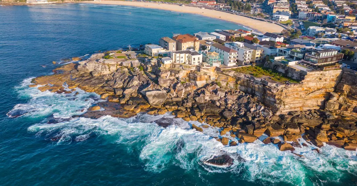 Stunning aerial shot of Bondi coastline with vibrant ocean and rocky shore in Sydney, Australia.