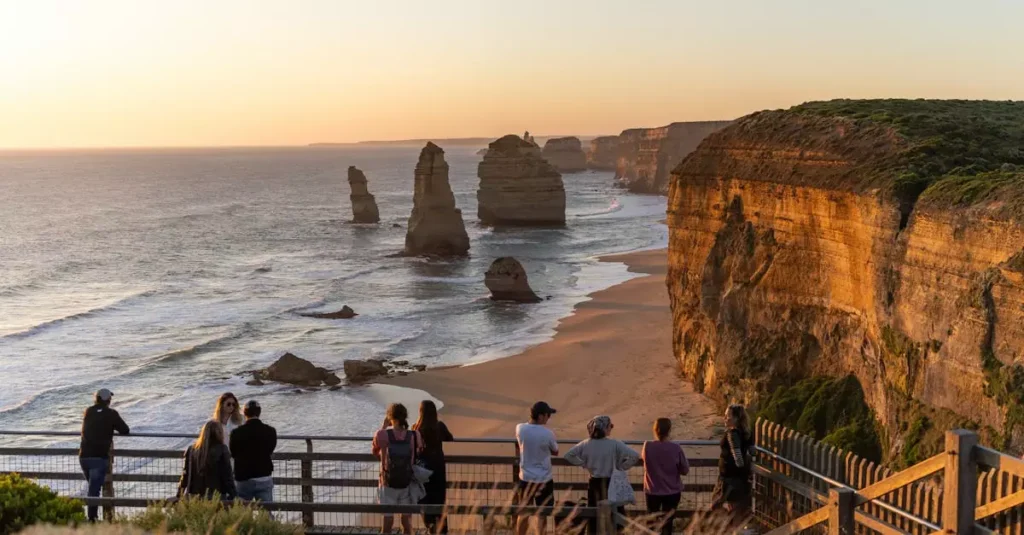 Best Australian Outdoor Adventures: Coastal to Outback 2 Stunning sunset view of the Twelve Apostles, Victoria, Australia, with tourists enjoying the iconic coastal scenery.