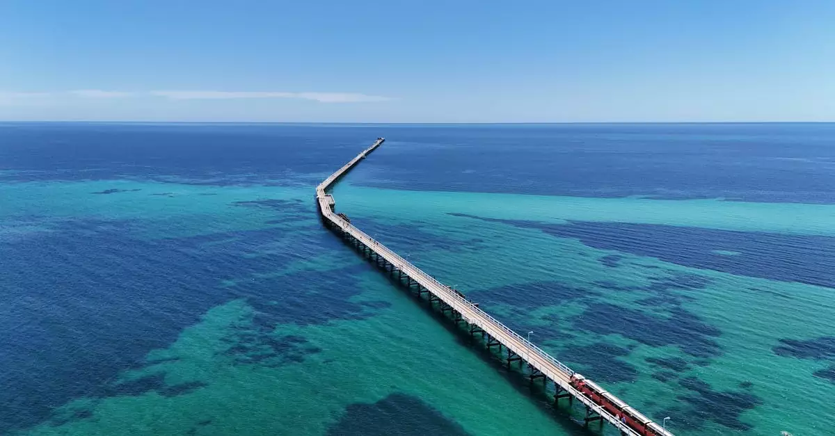 Stunning aerial view of Busselton Jetty extending over turquoise waters in Western Australia.