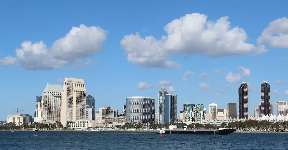 View of San Diego skyline with tall buildings and a ship on a bright day.