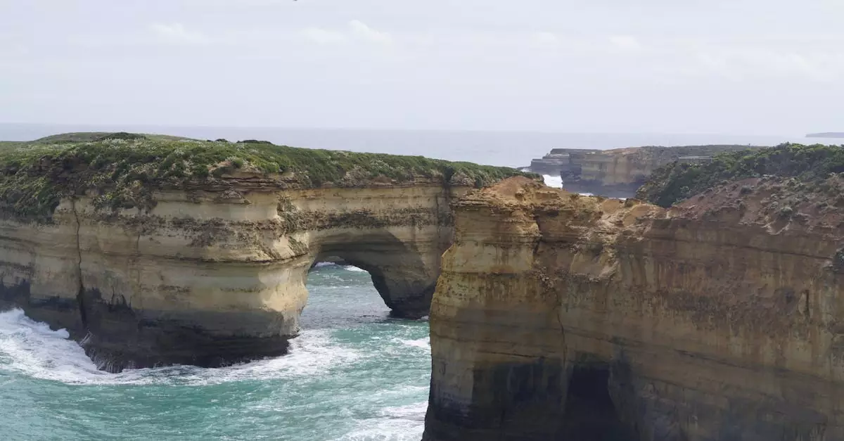 Breathtaking view of iconic cliffs and arch formations along the Great Ocean Road in Victoria, Australia.