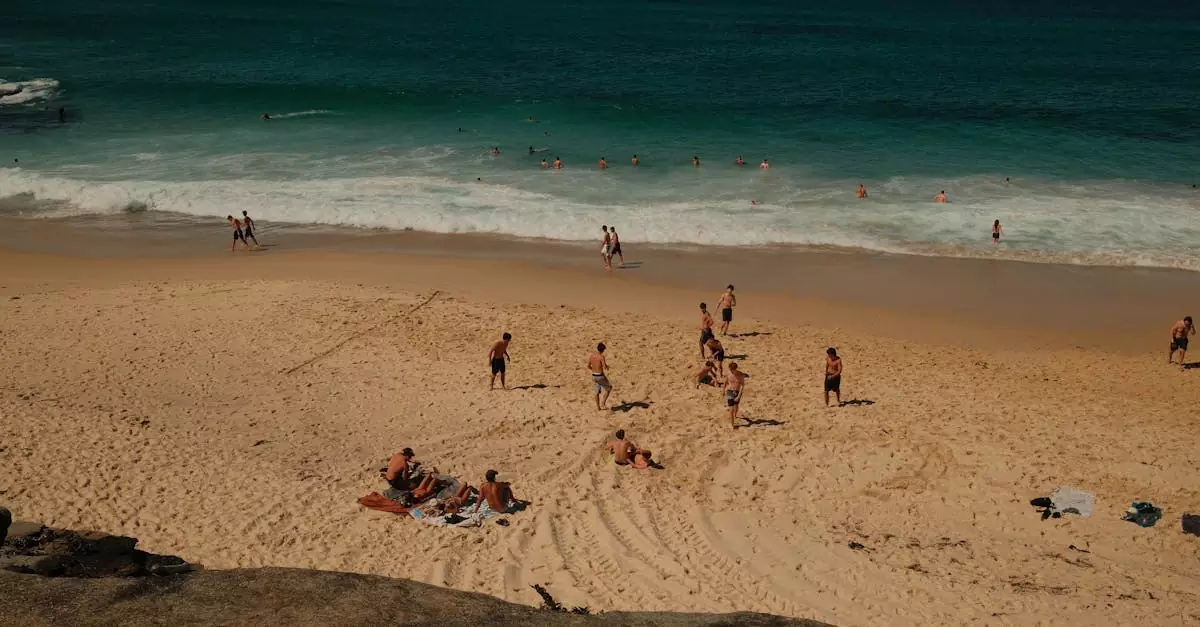 People enjoying a sunny day at the beach in Sydney, Australia with clear blue water and soft sand.