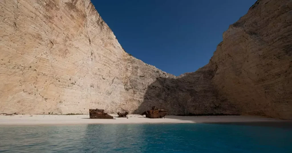 Explore Navagio Beach's iconic shipwreck and towering cliffs under clear blue skies.