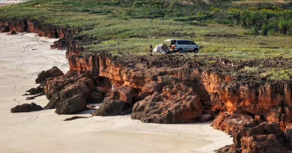 Scenic aerial view of campervan and tent on Dampier Peninsula cliffs, Western Australia.