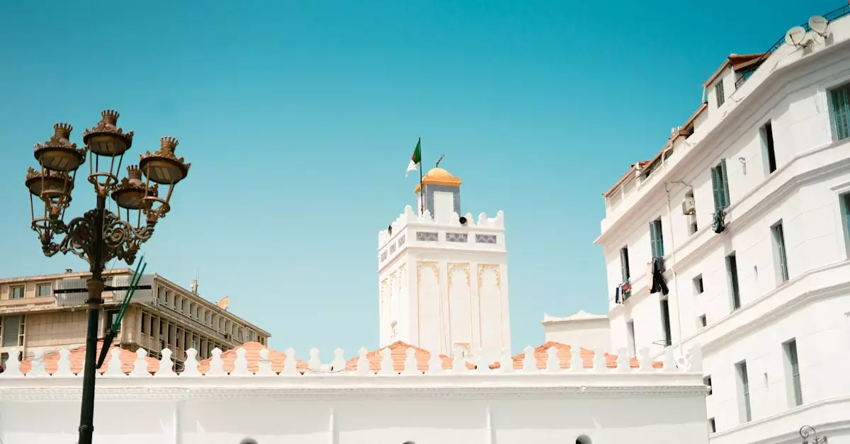 A vibrant scene of Alger Centre featuring historic buildings and the Great Mosque under a clear sky.