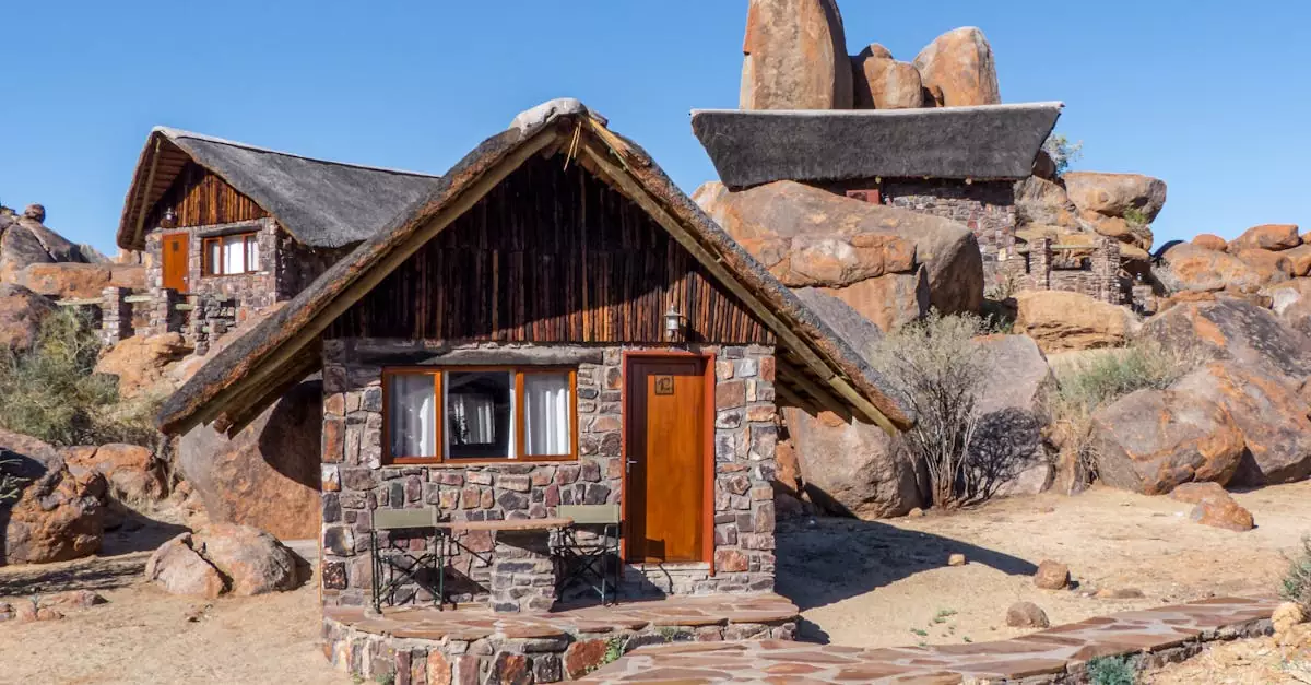 Cozy stone cabin nestled among natural rock formations in Namibia's desert setting.