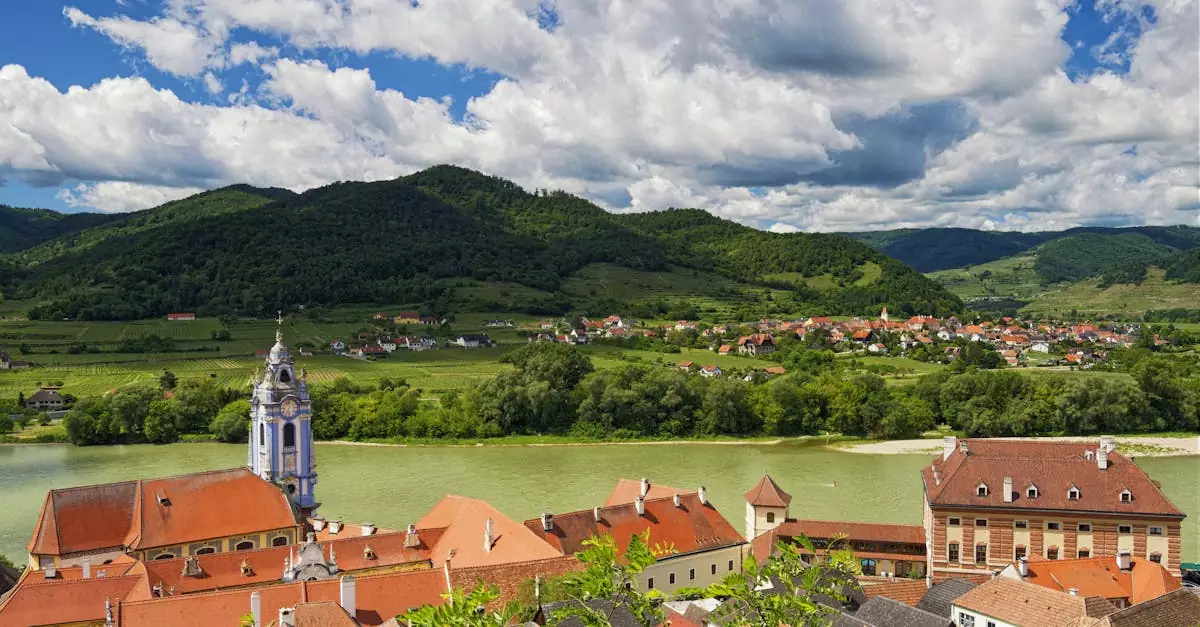 A stunning aerial view of D&uuml;rnstein, Austria with the Danube River and lush green hills.