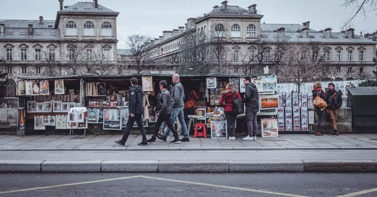 Bustling Paris street with vendors selling art and posters in front of historic buildings.