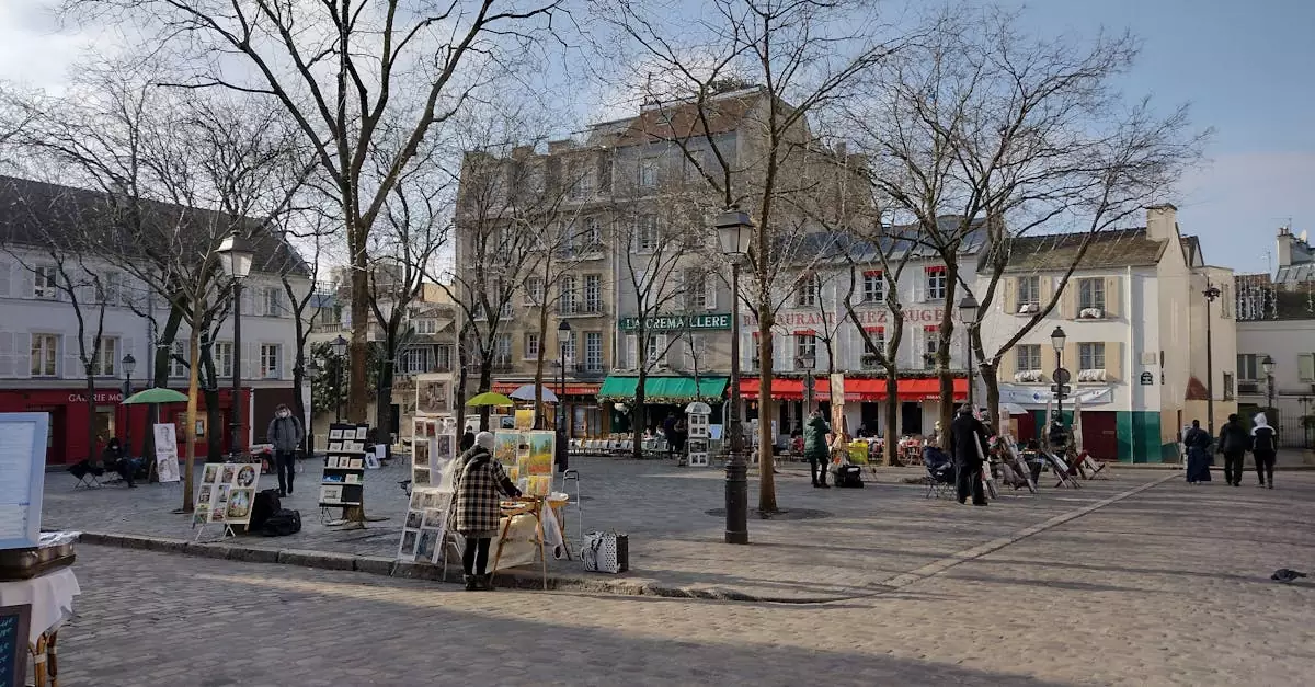 A picturesque street in Montmartre, Paris, featuring local artists displaying their work under leafless trees.