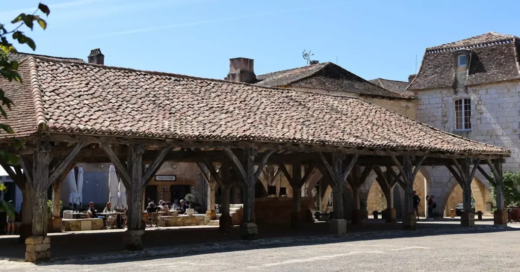 Best Food Markets in France: A Culinary Guide 2 Charming medieval market hall in a French village with rustic architecture.