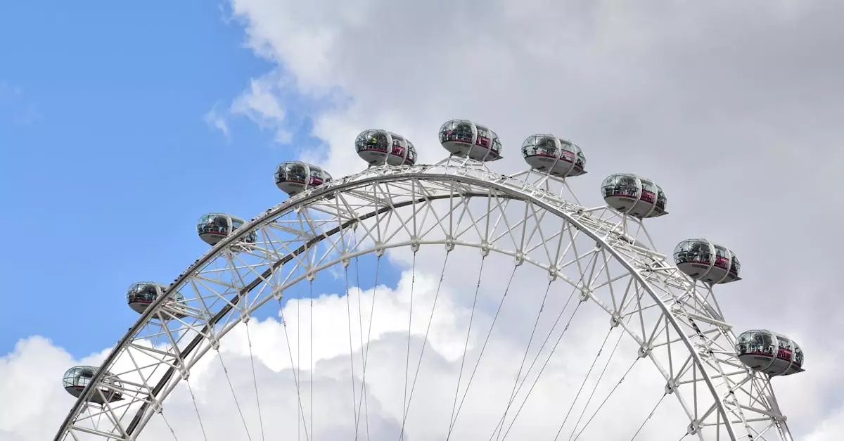 The iconic London Eye captured against a backdrop of white clouds and blue sky.