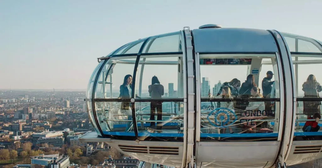 Tourists enjoying scenic views from the London Eye capsule in daylight.