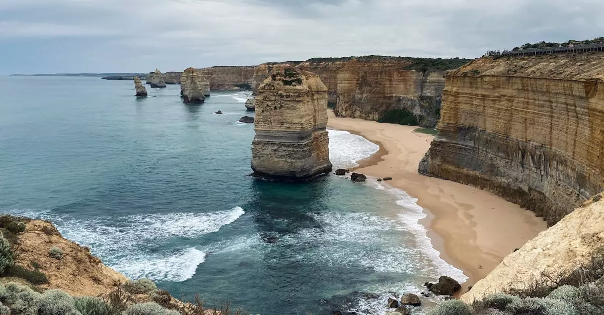 Stunning view of the Twelve Apostles with towering cliffs and waves crashing on the shore.