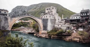 Explore the historic Stari Most bridge in Mostar, Bosnia, overlooking the scenic Neretva River.