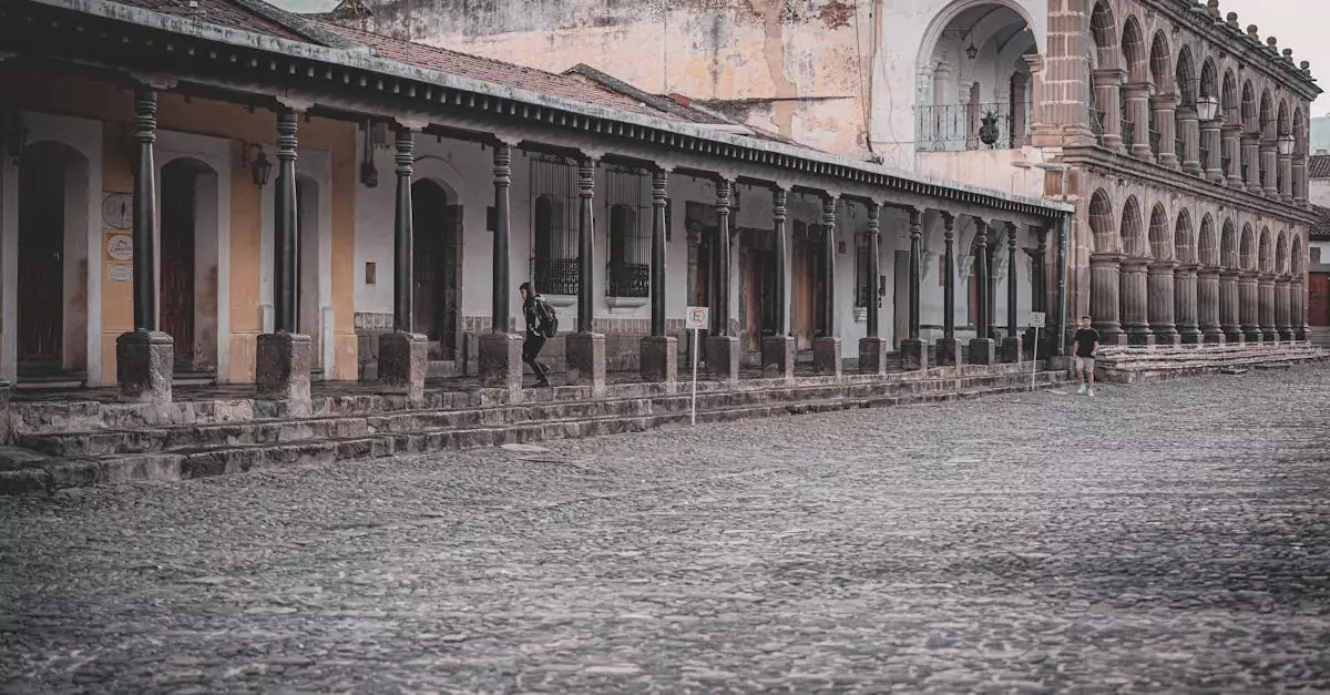 Elegant colonial buildings with stone archways and cobblestone streets in Antigua Guatemala.