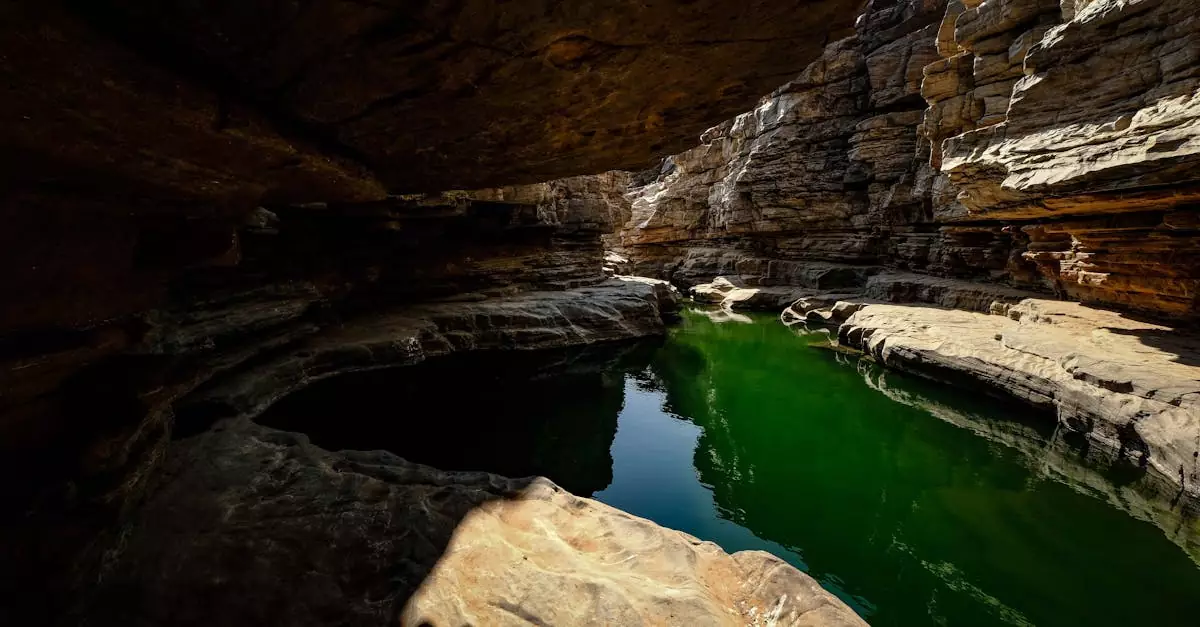 Explore the enchanting beauty of a limestone cave with a serene reflection pool beneath.