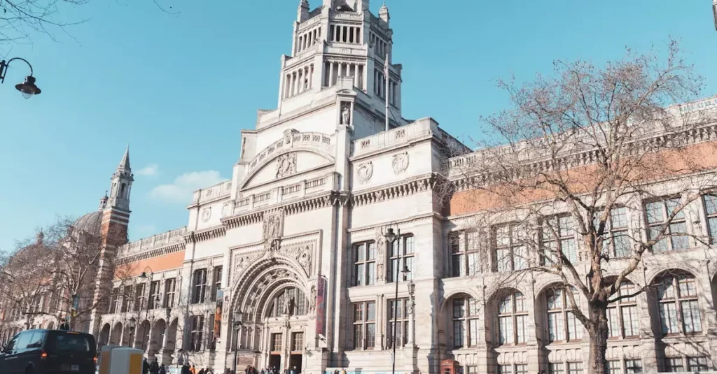 Exterior of the iconic Victoria and Albert Museum under clear skies in London, England.