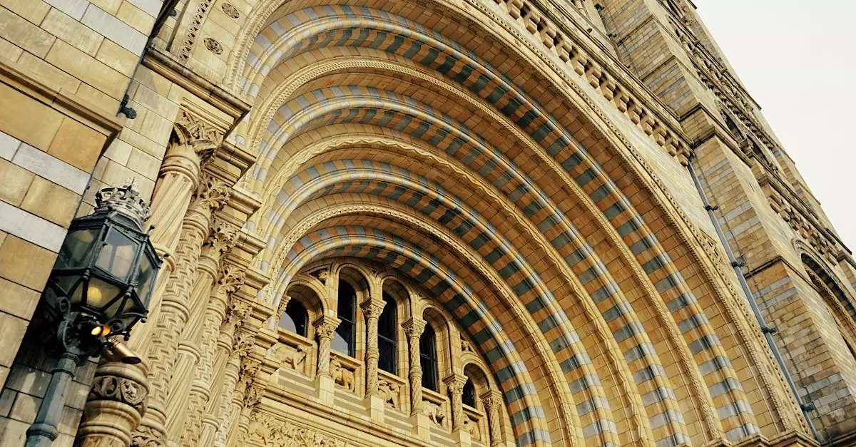 Intricate facade of the Natural History Museum in London showcasing arched windows and detailed stonework.