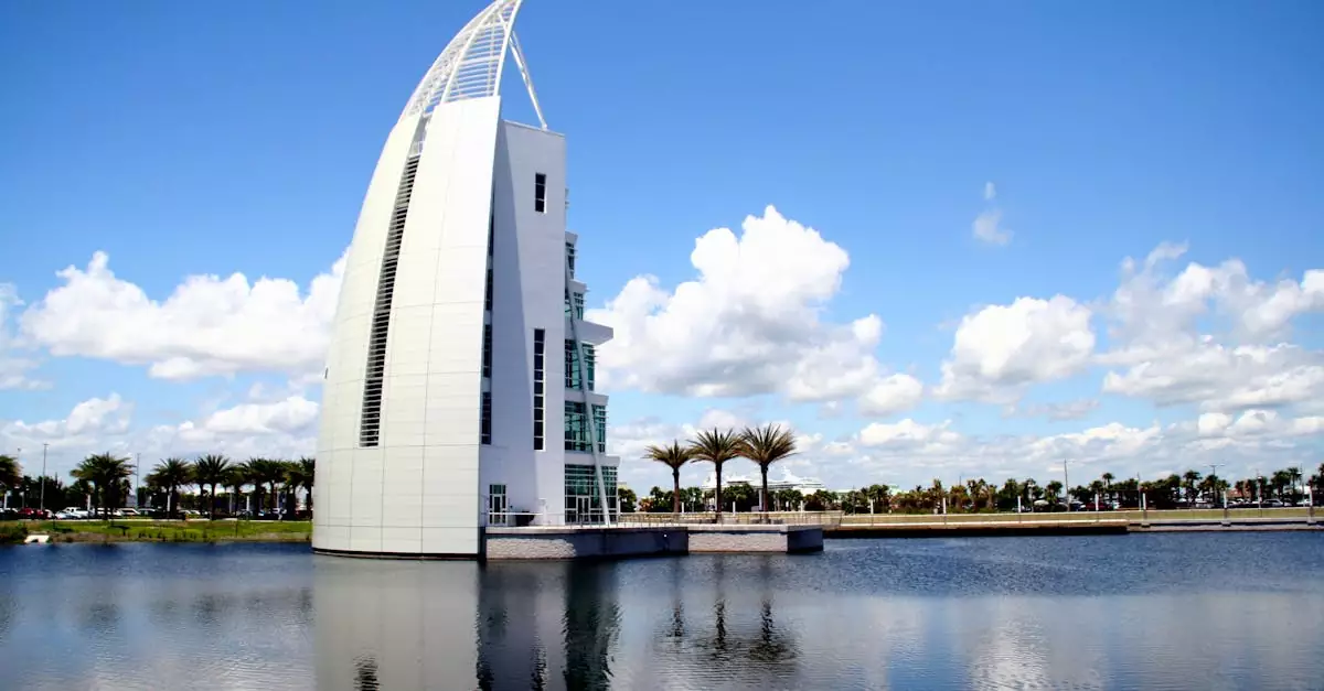 Sleek architectural structure reflecting on water under a bright blue sky in Cape Canaveral, Florida.