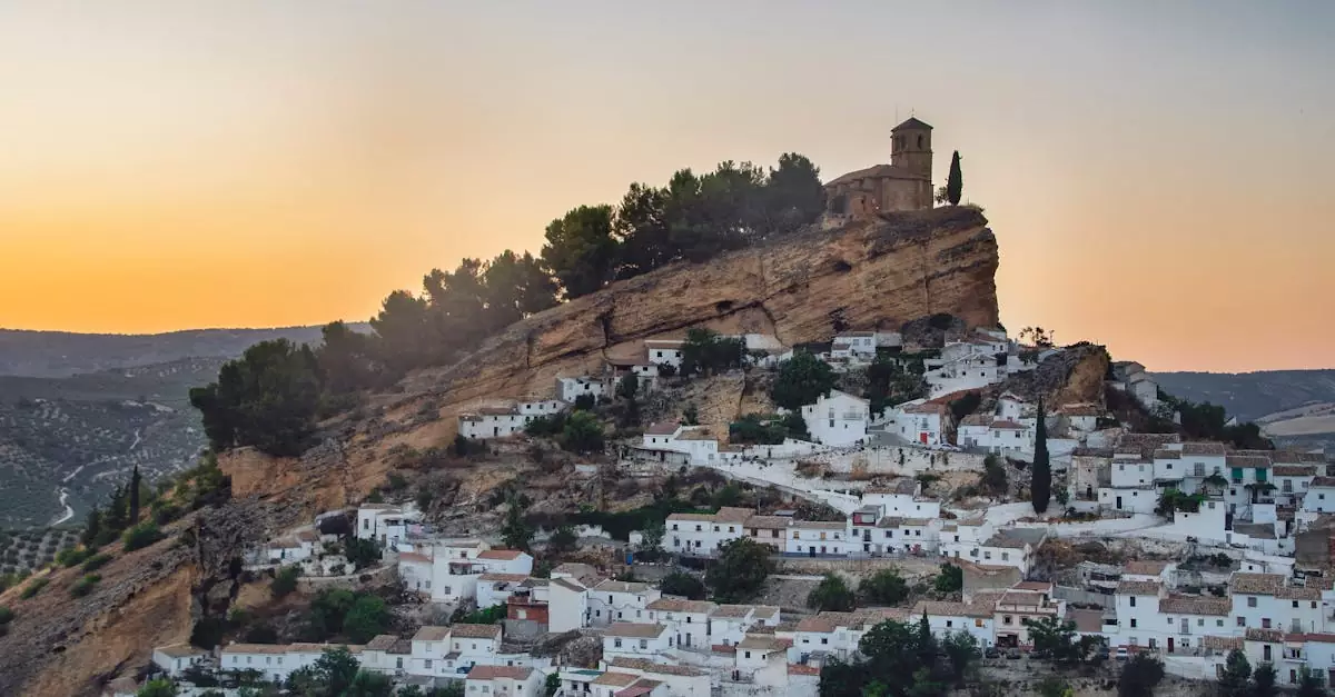 Picturesque view of Montefrio's iconic hilltop church and town at sunset.