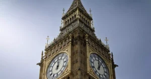 A close-up view of London's famous Big Ben clock tower under a clear blue sky.