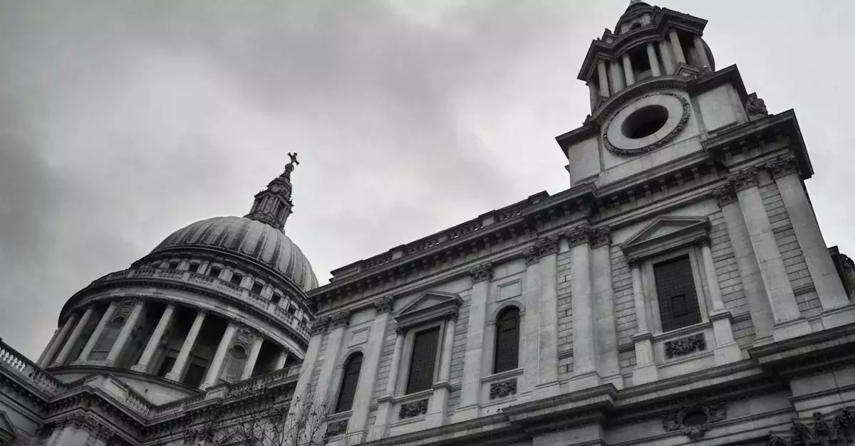 A dramatic view of St Paul's Cathedral in London, emphasizing its classic architecture against a moody sky.
