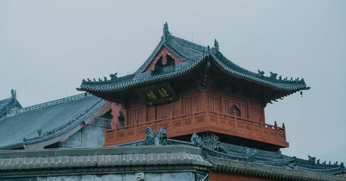 Exterior view of a historical Asian palace with intricate roof designs under a cloudy sky.