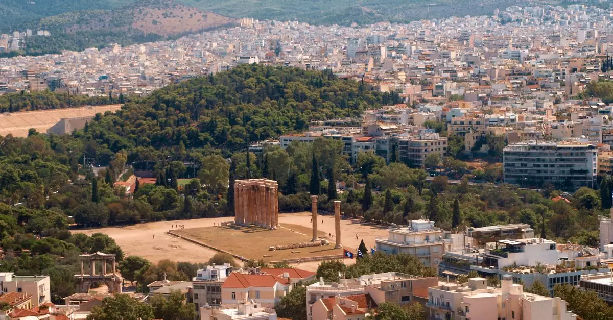 Explore the stunning aerial view of Athens including the Temple of Olympian Zeus, a historic landmark in Greece.
