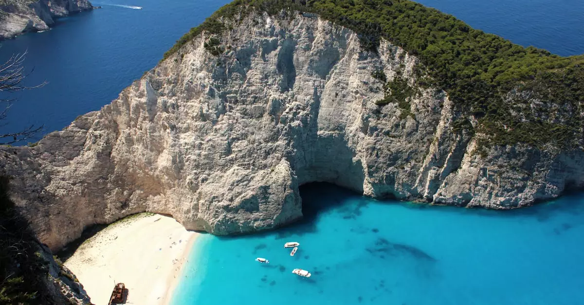 Breathtaking aerial view of Navagio Beach with a towering cliff and clear blue water in Zakynthos, Greece.