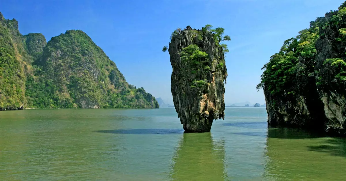 A stunning view of James Bond Island in Thailand's Phang Nga Bay with clear blue skies.