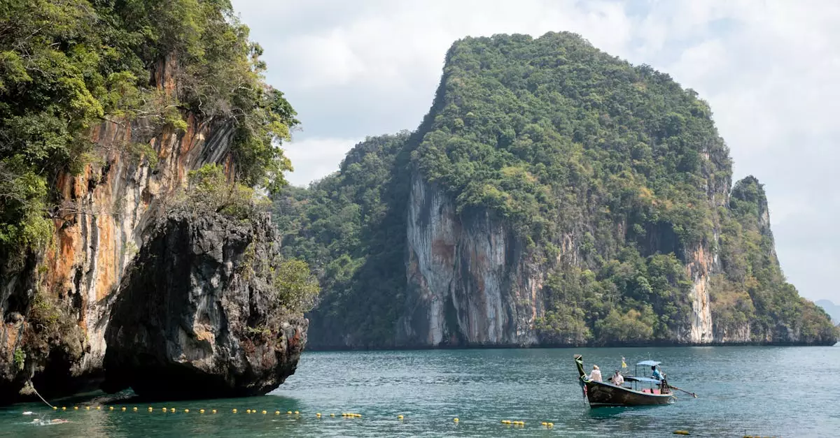 Spectacular limestone cliffs with a traditional boat in Krabi, Thailand's pristine waters.