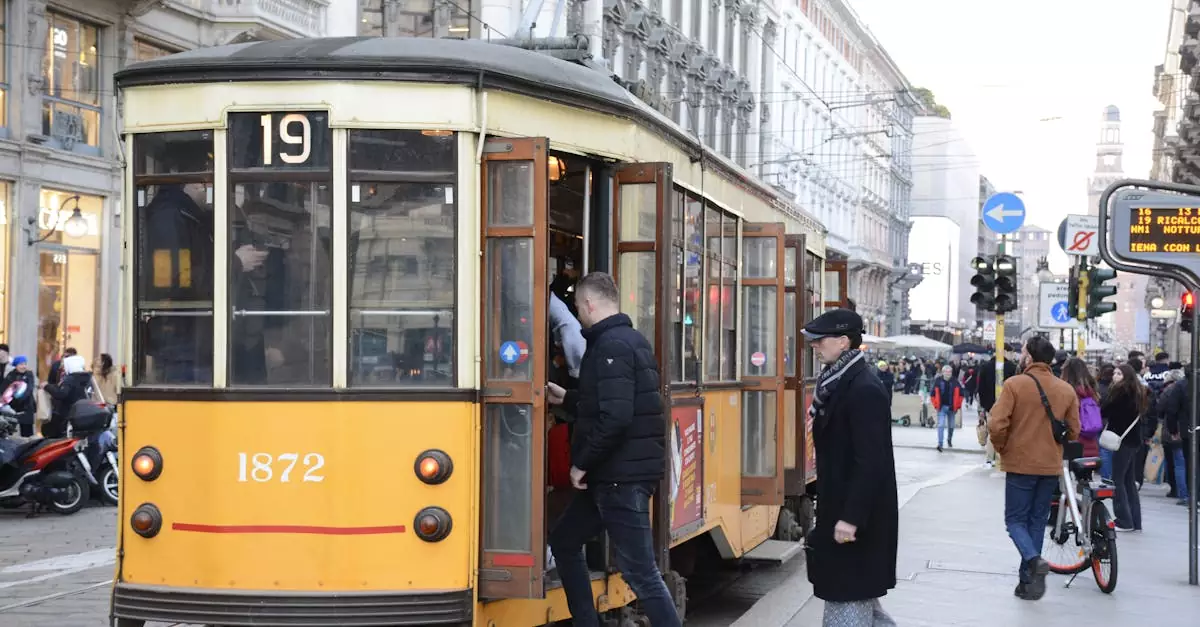 A classic yellow tram navigates the bustling streets of Milan during the day.