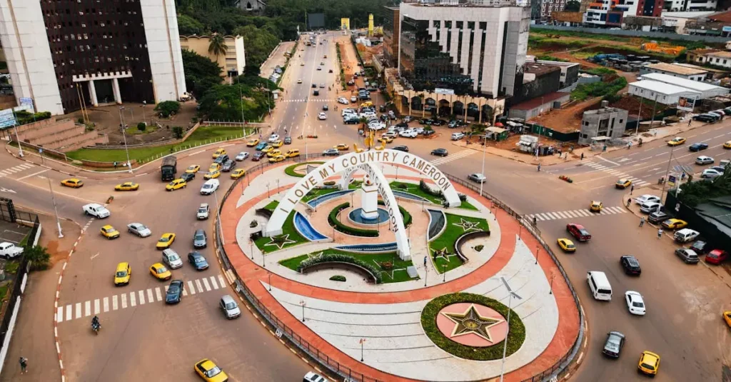 Best Local Foods Africa: A Culinary Journey 2 Aerial shot of a busy roundabout in Yaoundé, Cameroon, with traffic and urban landscape.
