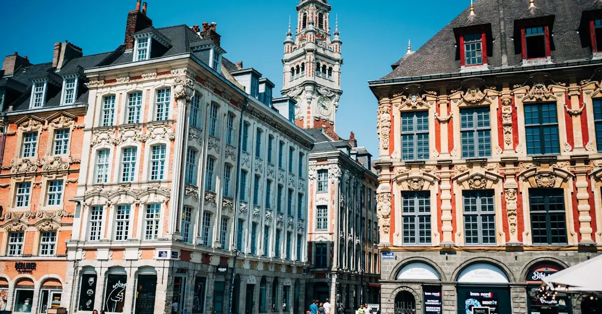 Ornate townhouses and belfry in Lille's Grand Place on a sunny day, showcasing local landmarks.