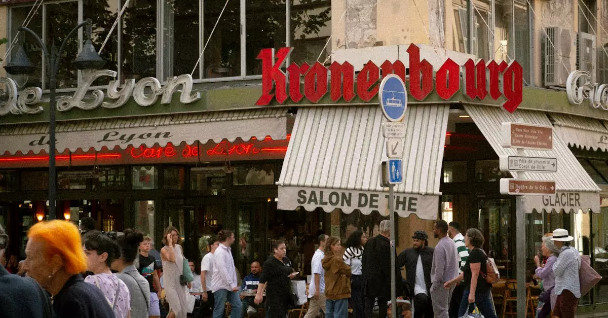 A lively crowd outside a caf&eacute; in France's city center featuring Kronenbourg sign.