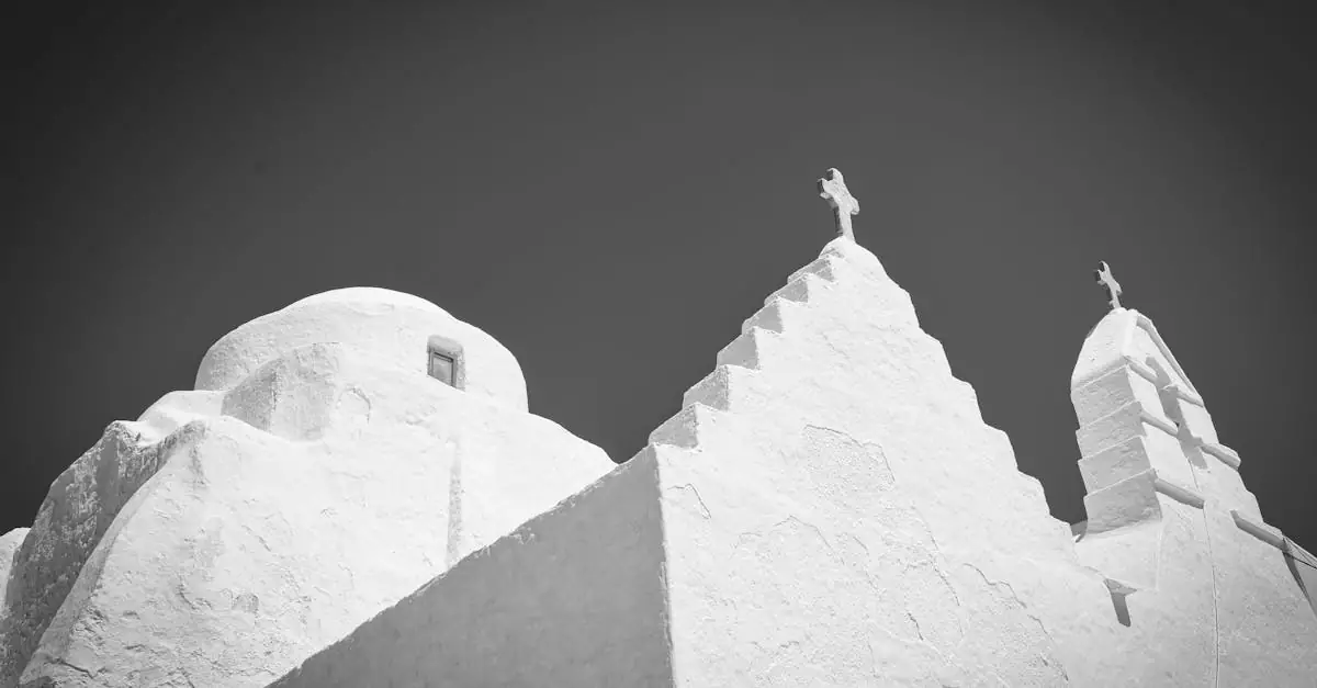 Minimalist black and white image of traditional Cycladic church architecture with crosses.