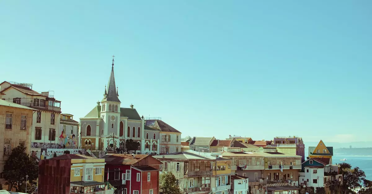 A beautiful view of Valparaíso's colorful houses and sea under a clear sky, capturing the city's charm.