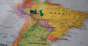 Close-up of a map of South America with pins marking locations in Brazil and Bolivia.