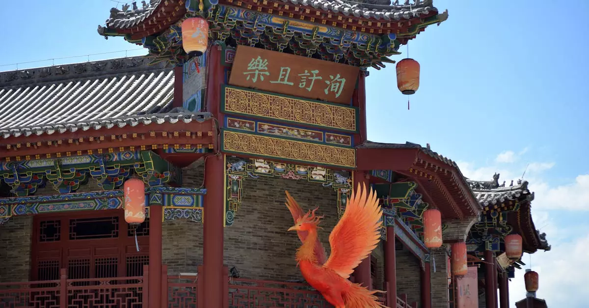 Colorful Chinese architectural detail with phoenix sculpture under a bright blue sky.
